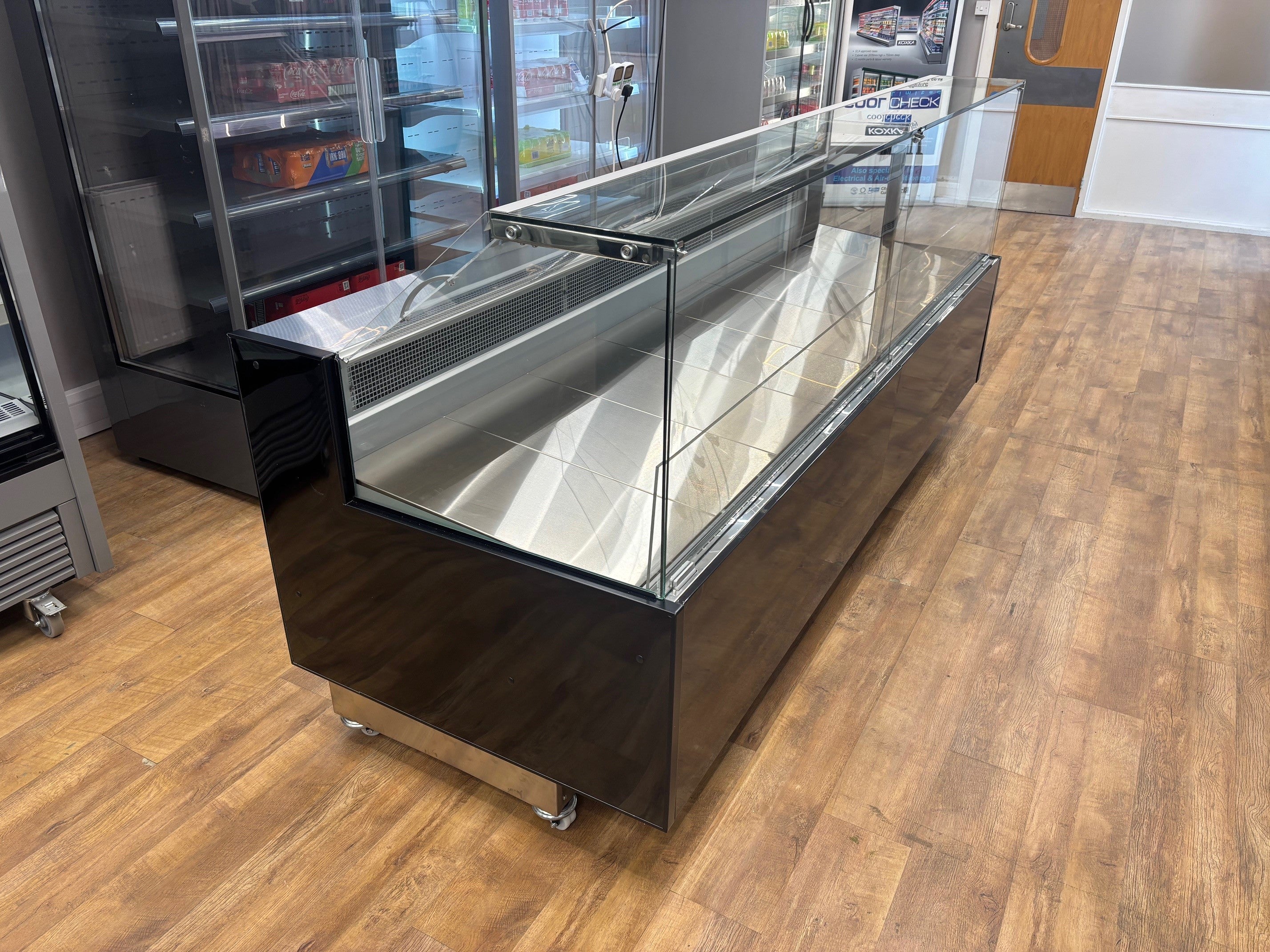 Fridges World Arneg serve over counter fridge with straight glass front, black finish, and LED lighting – ideal for meat and deli display